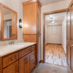 1354 Lucy Ln 2nd Floor Bathroom. Stained Maple Flat Panel Custom Cabinets. Wood Framed Mirror. Granite Countertops.