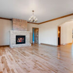 1354 Lucy Ln Great Room + Floor-to-Ceiling Brick Fireplace with Raised Hearth Extension.