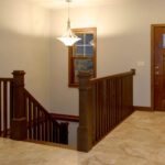 1800 Sonata Foyer with Stainable Fiberglass Entry Door + Stairs with Square Wood Balusters
