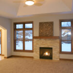 1800 Sonata Great Room + Fireplace with Stacked Stone Surround to Mantel Height.