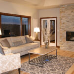 3424 Schubert Living Room. Stacked Stone Fireplace Surround. Natural Maple Hardwood Floors.