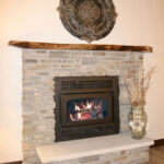 3435 Schubert Fireplace. Natural Stone Surround. Reclaimed Timber Mantel. Raised Hearth Extension.