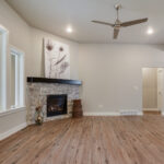 3492 Yorkshire Great Room + Stacked Stone Fireplace to Mantel Height. Luxury Vinyl Plank Floors. Painted Woodwork.