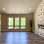 7714 Saint Andrews Great Room + Stacked Stone Linear Fireplace.