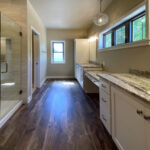 7714 Saint Andrews Owners Bathroom. Granite Countertops. Tiled Shower. Painted Flat Panel Cabinets. Makeup Counter.