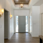 N3101 Right of Way Road Foyer + Stained Maple Nickel Gap Shiplap Tray Ceiling. 4-Panel Interior Doors.