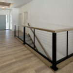 N3101 Right of Way Road Foyer + Stairs. Stained maple shiplap ceiling planks. Cable railing with wood guard rail.