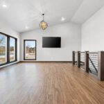 311 S Splake Great Room + Stairs. Custom Boxed Newels + Linear Tube Railing. Vaulted Ceiling.