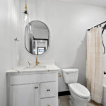 311 S Splake Main Bathroom. Stone Countertops. Black Framed Mirror.