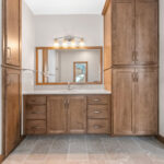 3597 E Hank Owners Bathroom Vanity. Stained Maple Custom Cabinets. Ceramic Tile Floors. Stone Countertops. Ceramic Tile Flooring.