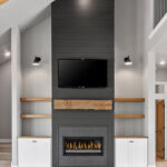 704 Royal St Pats Fireplace Shiplap 704 Royal St Pats Shiplap Fireplace. Black Painted Shiplap (Sherwin-Williams Iron Ore SW-7069) Fireplace Surround with Mitered Corners and Reclaimed Hewn Timber Mantel. Stained Maple Floating Shelves. TV Above Fireplace. Luxury Vinyl Plank Flooring. Hewn Timber Ceiling Beams at Vaulted Ceiling. Black Windows with White Painted Trim.