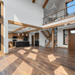10510 Sugar Creek Foyer + Open Riser Stairs. Maple Glu-Lam, Black Cable Rail, Ceiling Beams.