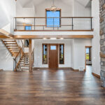 10510 Sugar Creek Foyer + Open Riser Stairs. Maple Glu-Lam, Black Cable Rail, Ceiling Beams.
