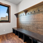 10510 Sugar Creek Mud Room. Maple Bench with Board, Coat Hooks, Shelf & Shiplap. Vinyl plank flooring. Black interior window.