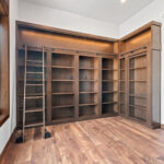10510 Sugar Creek Office. Built-In Maple Bookcases with Ladder Rail & Hidden Murphy Door.
