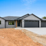 4749 Whitefish Bay Exterior. Gentek Hudson Slate Siding with Black Soffit & Fascia, Black Windows & Doors, and SW 3559 Canyon Brown Stained Cedar Post.