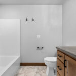 4749 Whitefish Bay Owners Bathroom. Knight Tile River Marble Vinyl Tile Floors. Stained Maple Vanity.