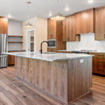 9185 Rasner Kitchen. Vertical Grain Black Walnut Slab Front Modern Cabinets. Alpine White Granite Countertops. Floating Shelves. Aquarelle 0 Vapor Tiled Backsplash. Farrington Crest Cigar Hickory Laminate Plank Flooring.