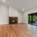 9185 Rasner Living Room & Fireplace. Farrington Crest Cigar Hickory Laminate Plank Flooring. Cabot Black Jade Brass Inlay Fireplace Tiled Surround.