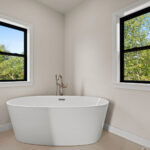 9185 Rasner Way American Standard Coastal Serin Freestanding Soaking Tub. Angora Station Ivory Floor Tile. Champagne Bronze Fixture.