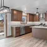 237 Park St Kitchen + Dining. White Valley Stone Countertops. Stained Maple Cabinets. Courtier "Admiral Oak" Vinyl Plank Floors.