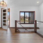3409 Schubert Foyer + Stairs. 8'-0" Tall Front Entry Door. Custom Square Maple Newel Posts with Glass Railing.
