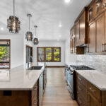 3409 Schubert Kitchen. Mont Blanc Quartzite Countertops. Kentmore Lodge "Natural Canvas Oak" Vinyl Plank Flooring. Wood Hood.