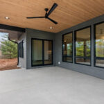 3409 Schubert Rear Covered Porch. T&G Cedar Porch Ceiling Stained with Sherwin-Williams "Crossroad" Semi-Transparent SW-3521. Black Windows. DiamondKote Terra Bronze LP SmartSide siding.