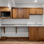 7120 Morrison Rd Basement Kitchenette. Slab Front Stained Maple Cabinets.