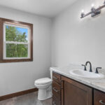 4673 Mill Rd Main Bathroom. Formica "Silver Quartzite" Laminate Countertops. Origins "Newton" Vinyl Tile.