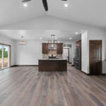 4673 Mill Rd Main Living Areas. Lone Star Spirit "Ballroom Rodeo" 9" Wide Vinyl Plank Flooring. Cathedral Ceiling. Stained Maple Woodwork.