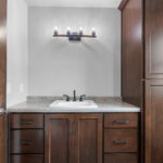4673 Mill Rd Owners Bathroom. Stained Maple Vanity & Linen. Formica Elemental Stone Laminate Countertops.