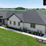 E1999 Hillside Exterior. White Board & Batten Siding. White Windows with Black Trim Boards. CertainTeed "Moire Black" Shingles. Black Fascia.