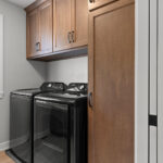 E1999 Hillside Laundry. Kentmore Lodge "Natural Canvas Oak" Vinyl Plank Flooring. Stained Maple Cabinets with Hanging Pole & Shelf.